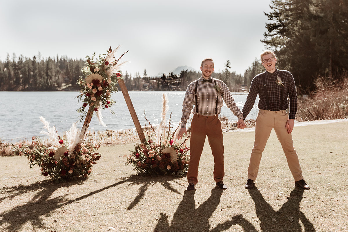 Iridescent bohemian wedding inspiration for the nature lover two grooms gingham plaid suspenders waterfront