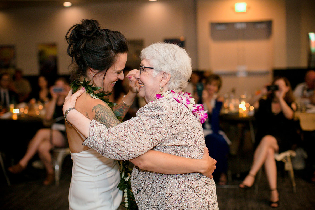 Modern intimate destination wedding with Hawaiian traditions dance with family member grandmother grandparent