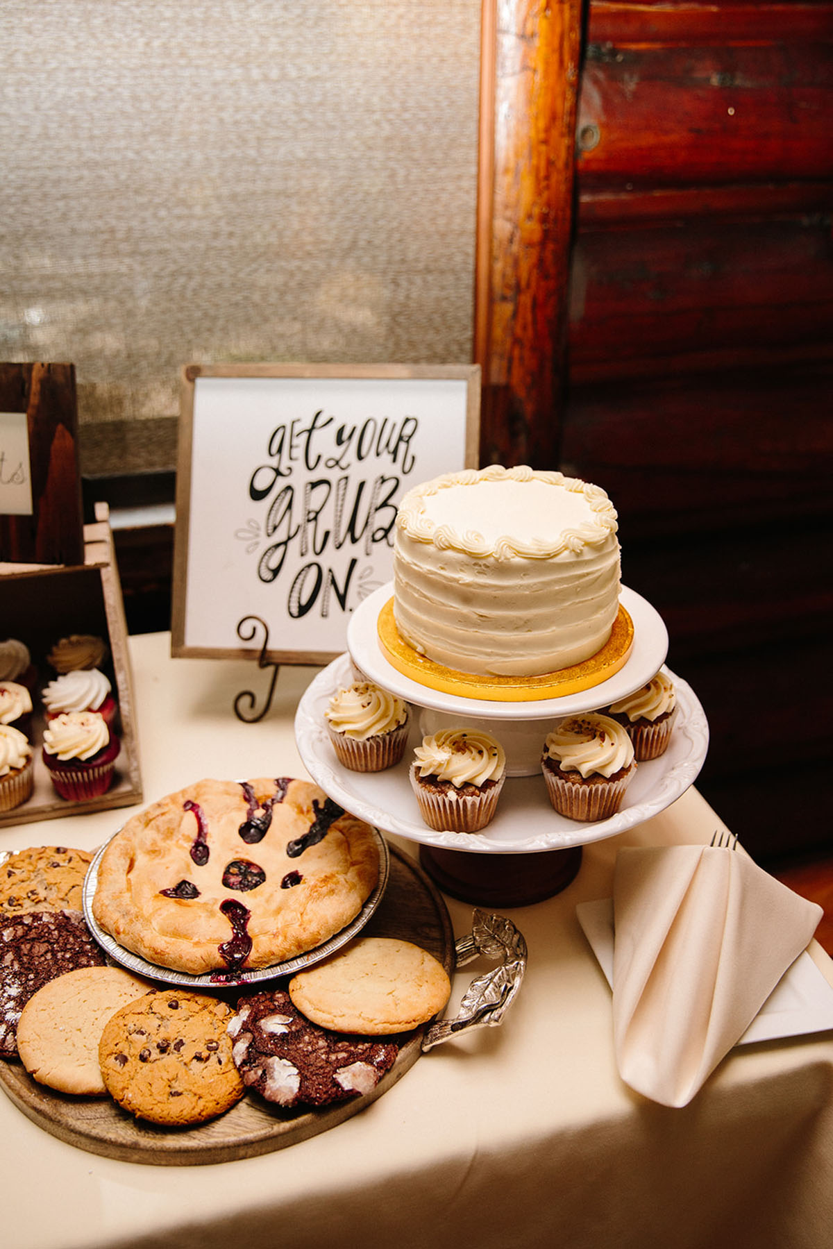 Rustic mountain wedding in the Colorado Rocky Mountains two brides lace white dresses veils dessert cake