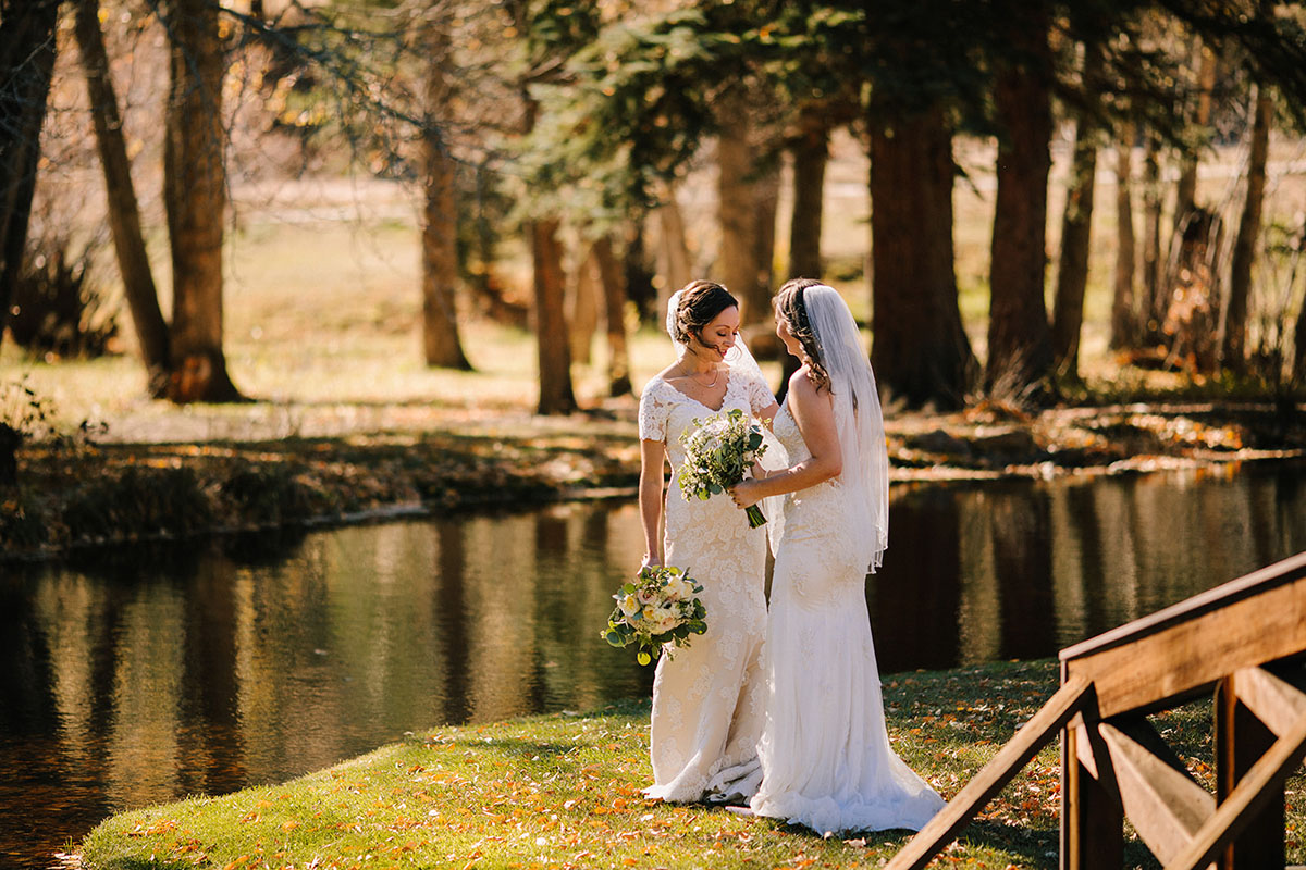 Rustic mountain wedding in the Colorado Rocky Mountains two brides lace white dresses veils