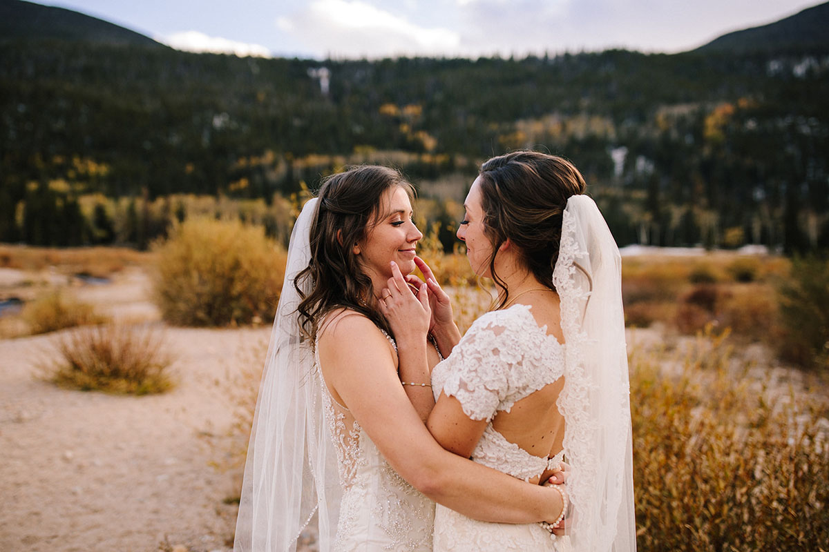 Rustic mountain wedding in the Colorado Rocky Mountains two brides lace white dresses veils