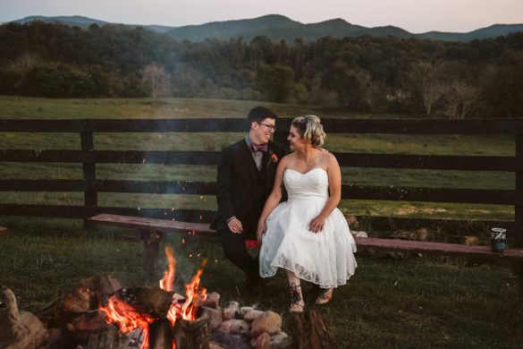 This moody fall ranch wedding in the Blue Ridge Mountains is a dream two brides lesbian wedding colorful boots roller derby skates purple bow tie dark tux white tea length dress crystal necklace rainbow sunset fire