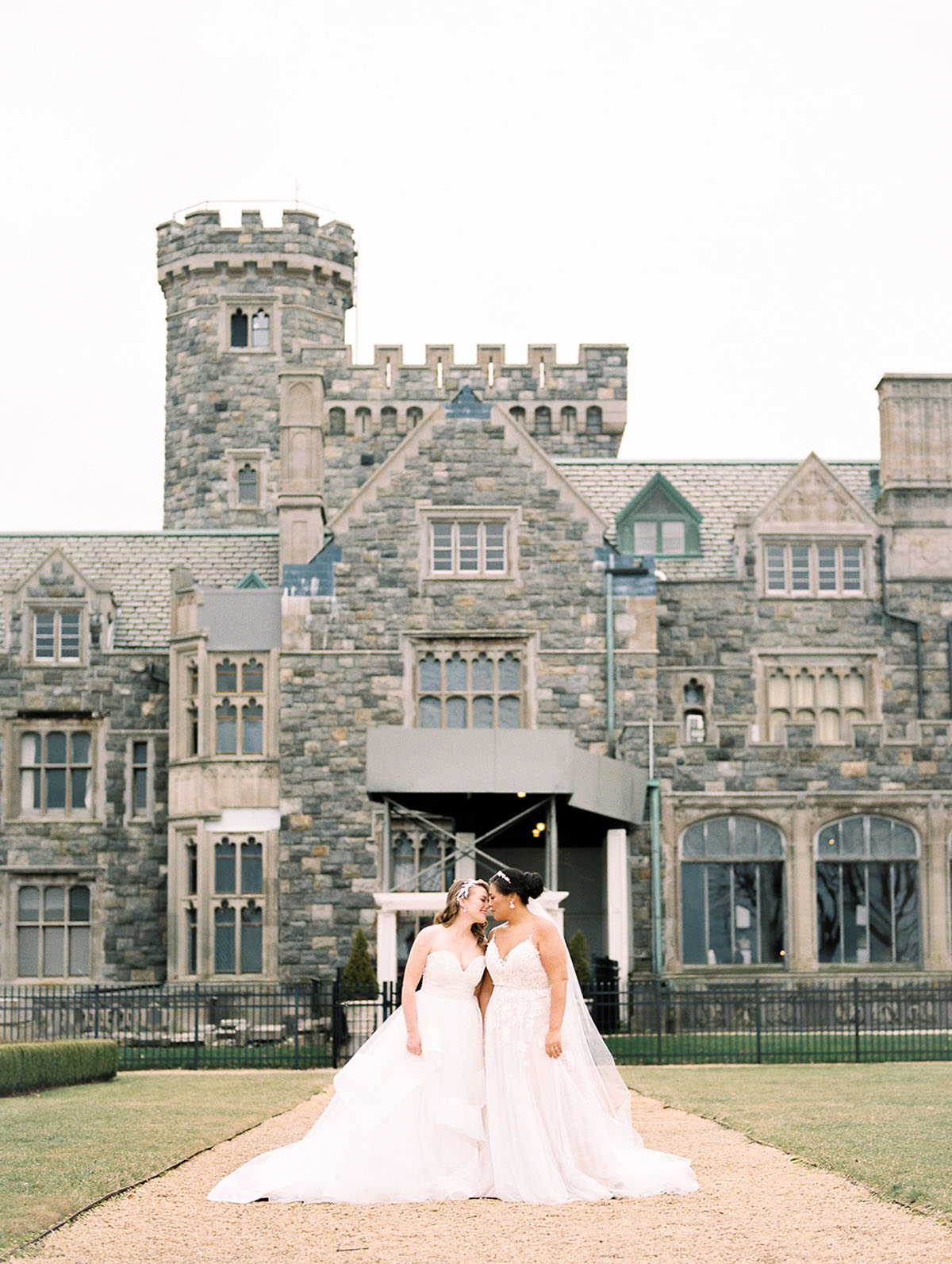 This romantic spring castle wedding is fit for a princess—or two two brides white lace dresses florals crystals diamonds