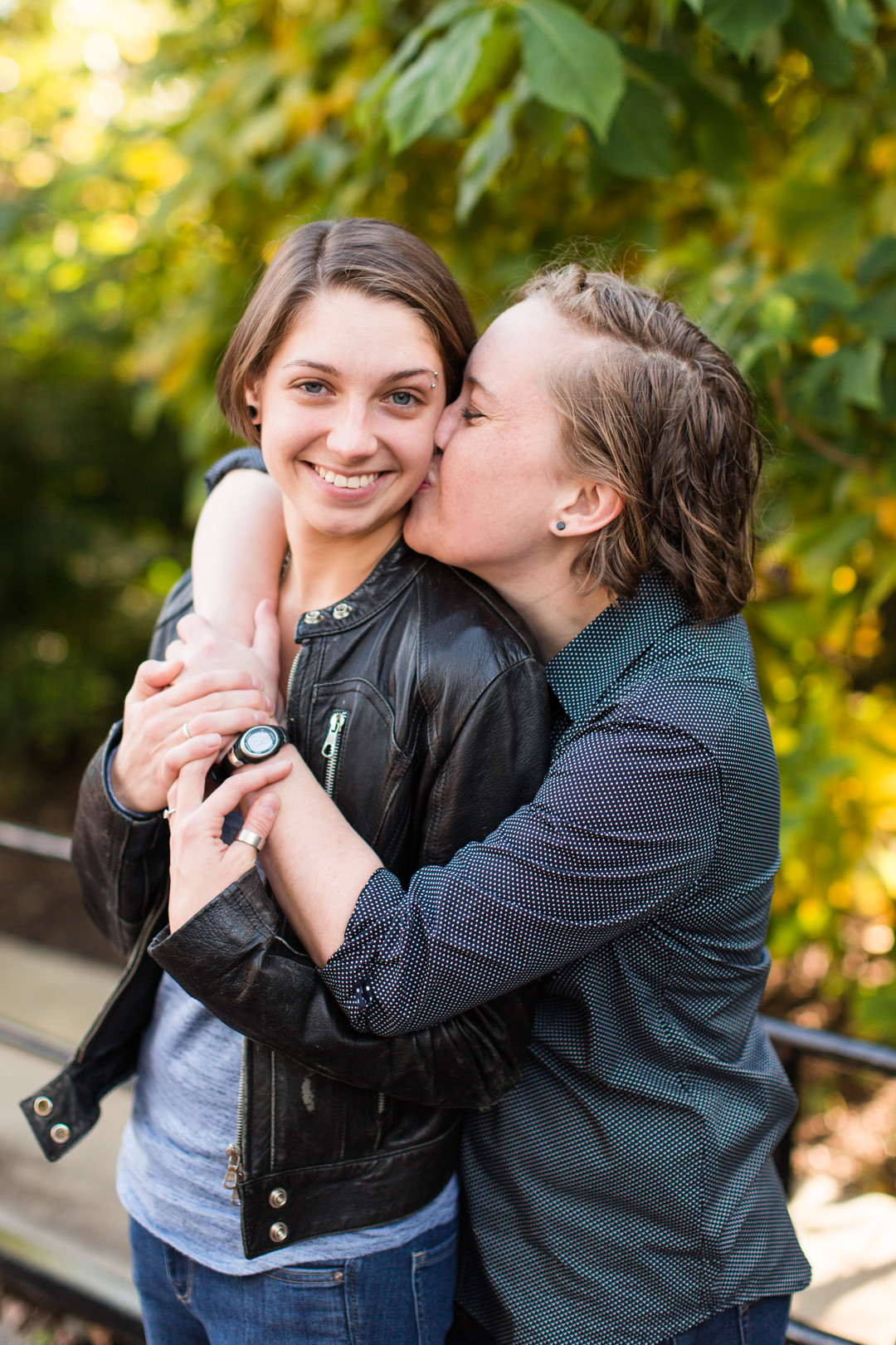 Fun wildlife engagement photos at the National Zoo two brides lesbian engagement leather jacket casual button down kiss