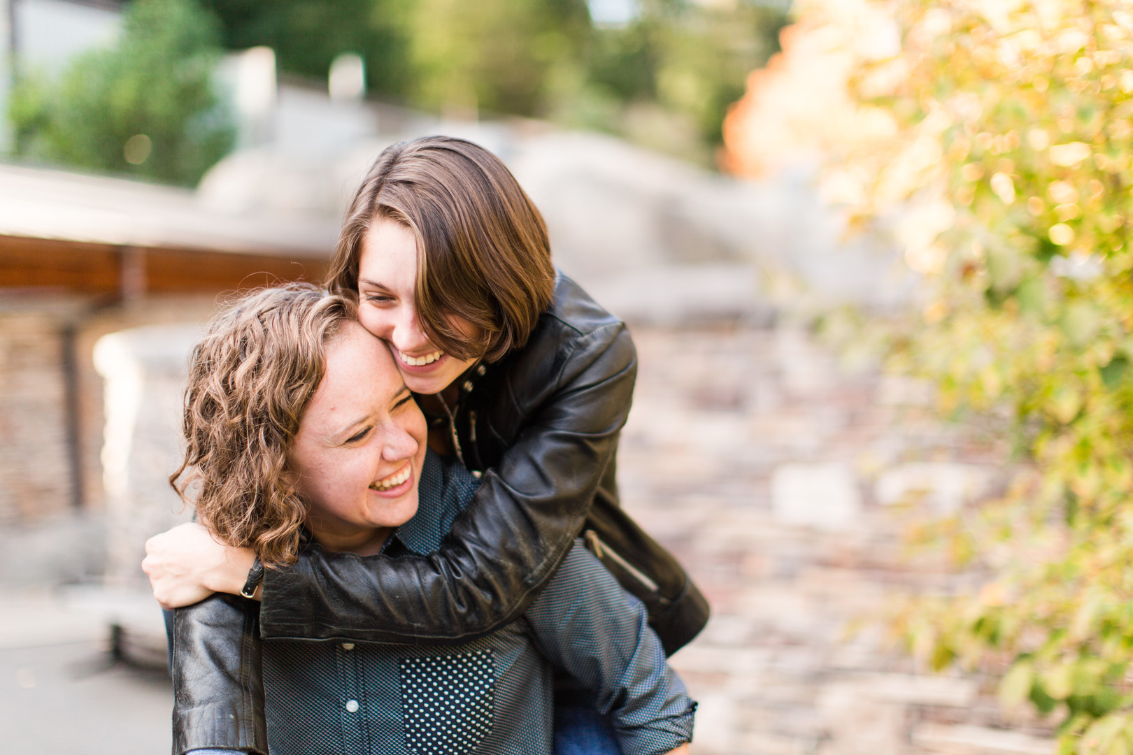 Fun wildlife engagement photos at the National Zoo two brides lesbian engagement leather jacket casual button down