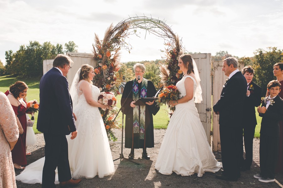 This fall countryside wedding has all the moody, romantic vibes you need two brides lesbian wedding autumn long white dresses vows