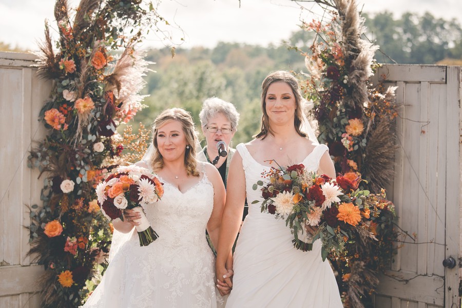 This fall countryside wedding has all the moody, romantic vibes you need two brides lesbian wedding autumn long white dresses