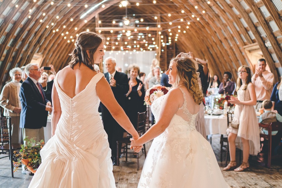This fall countryside wedding has all the moody, romantic vibes you need two brides lesbian wedding autumn long white dresses dance