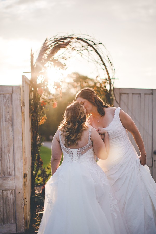 This fall countryside wedding has all the moody, romantic vibes you need two brides lesbian wedding autumn long white dresses kiss