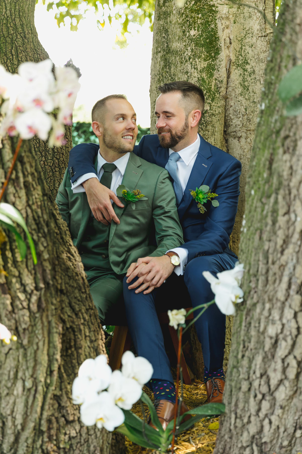 Blue and green garden wedding at Living Sculpture Sanctuary two grooms blue tuxedo green tuxedo outdoor wedding Florida gay