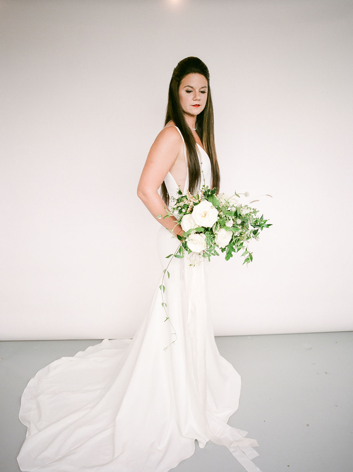 Crisp white modern wedding inspiration in Nashville, Tennessee two brides pantsuit dress candles natural greenery roses