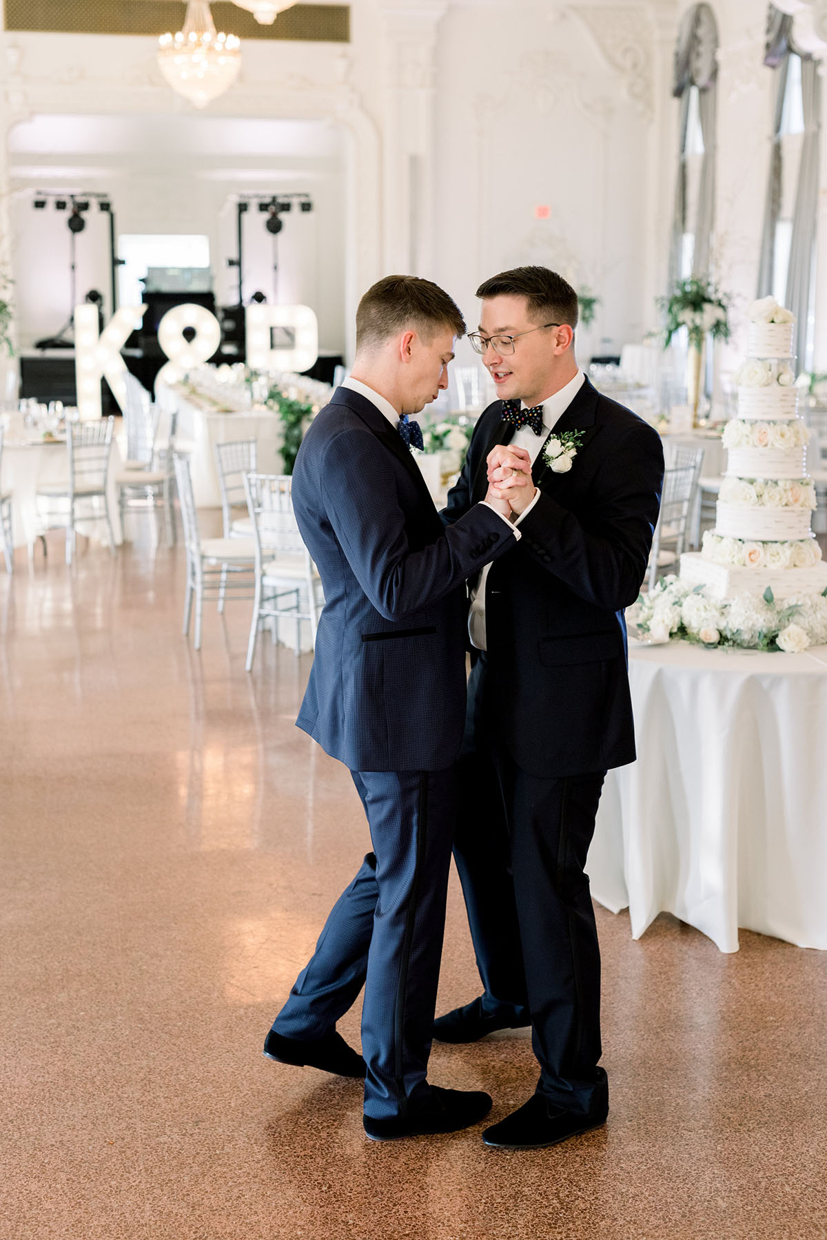 Elegant luxe historic hotel wedding in Tulsa, Oklahoma two grooms tuxedos bow ties luxurious gay wedding dance