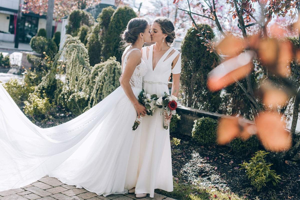 This romantic fall wedding has some seriously gorgeous foliage two brides updos long white dresses