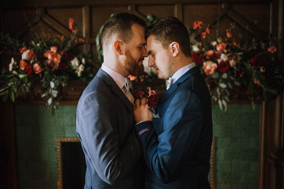 Timeless and romantic vintage library wedding inspiration two grooms blue tuxedos fall autumn colors intimate