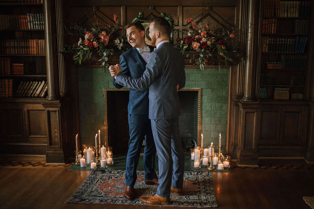 Timeless and romantic vintage library wedding inspiration two grooms blue tuxedos fall autumn colors dance