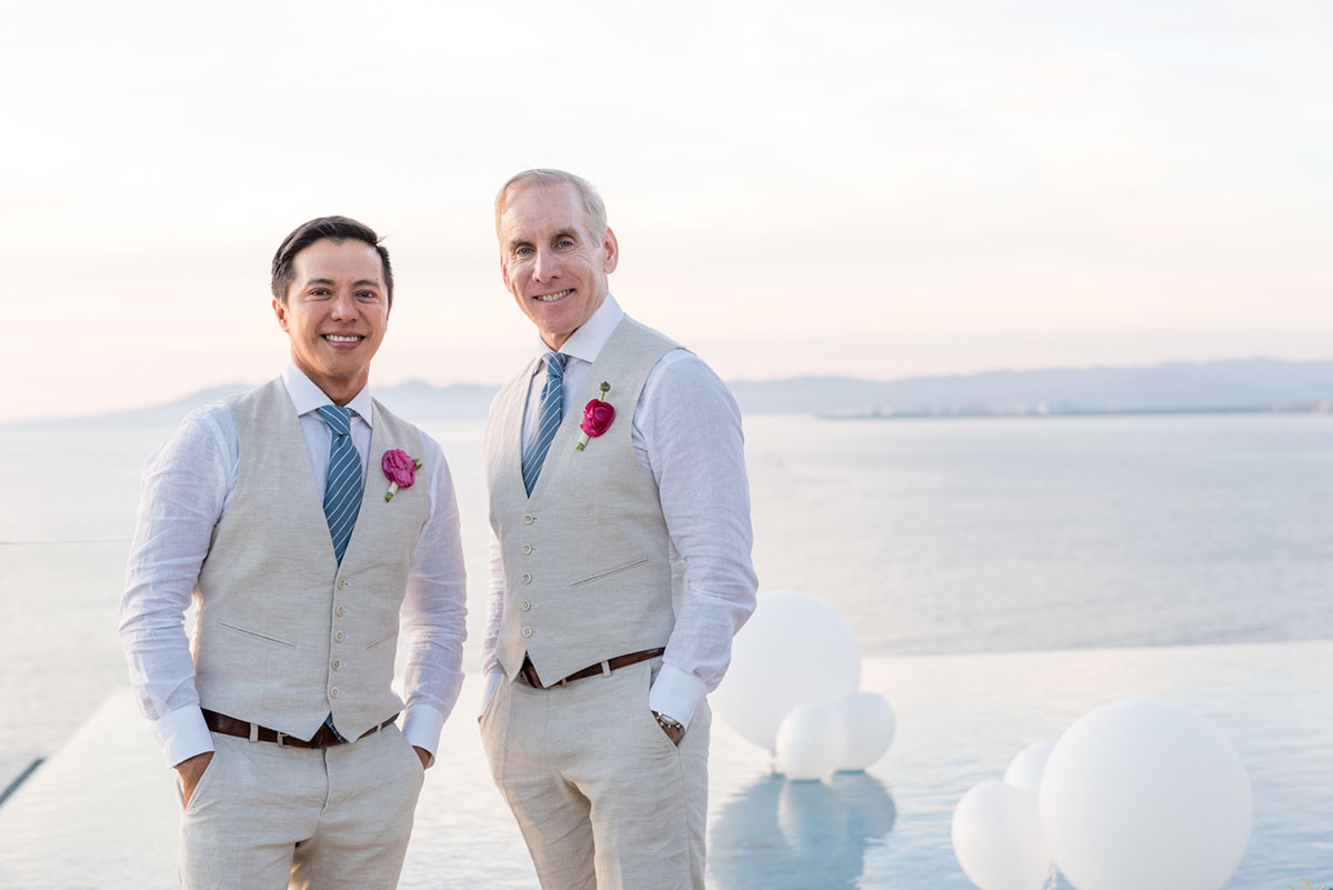Tropical destination white beach wedding in Puerto Vallarta, Mexico two grooms linen tailored suits tradition whimsical
