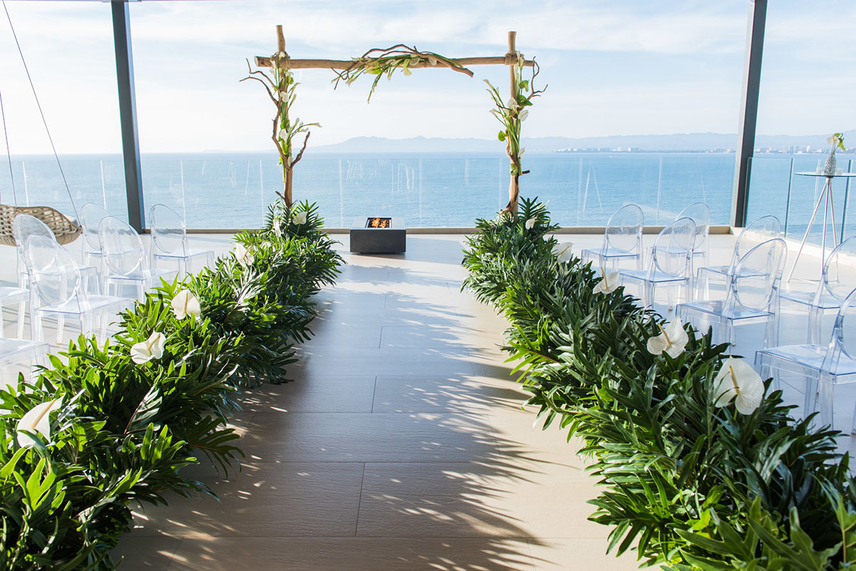 Tropical destination white beach wedding in Puerto Vallarta, Mexico two grooms linen tailored suits tradition whimsical ceremony