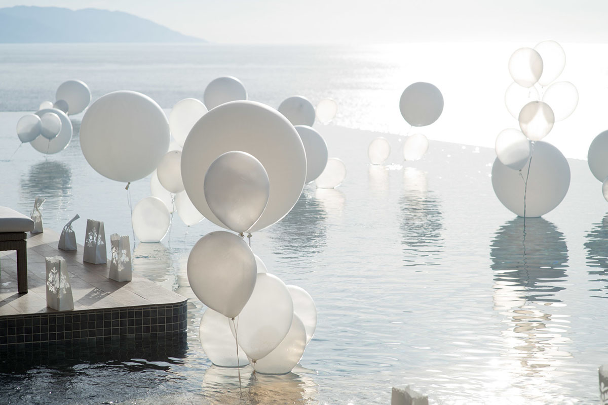 Tropical destination white beach wedding in Puerto Vallarta, Mexico two grooms linen tailored suits tradition whimsical balloons