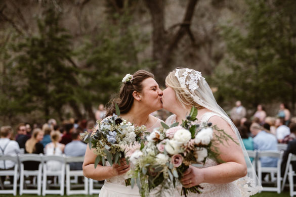 Elegant, woodsy mountain wedding in Boulder, Colorado lesbian spring wedding long white dresses kiss