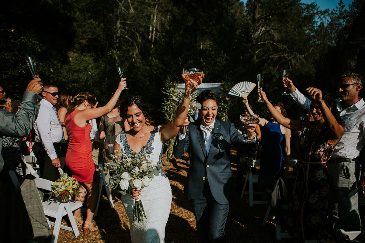Mediterranean and Jewish wedding in wine country two brides same-sex lesbian wedding California long white dress gray lace suit cheers