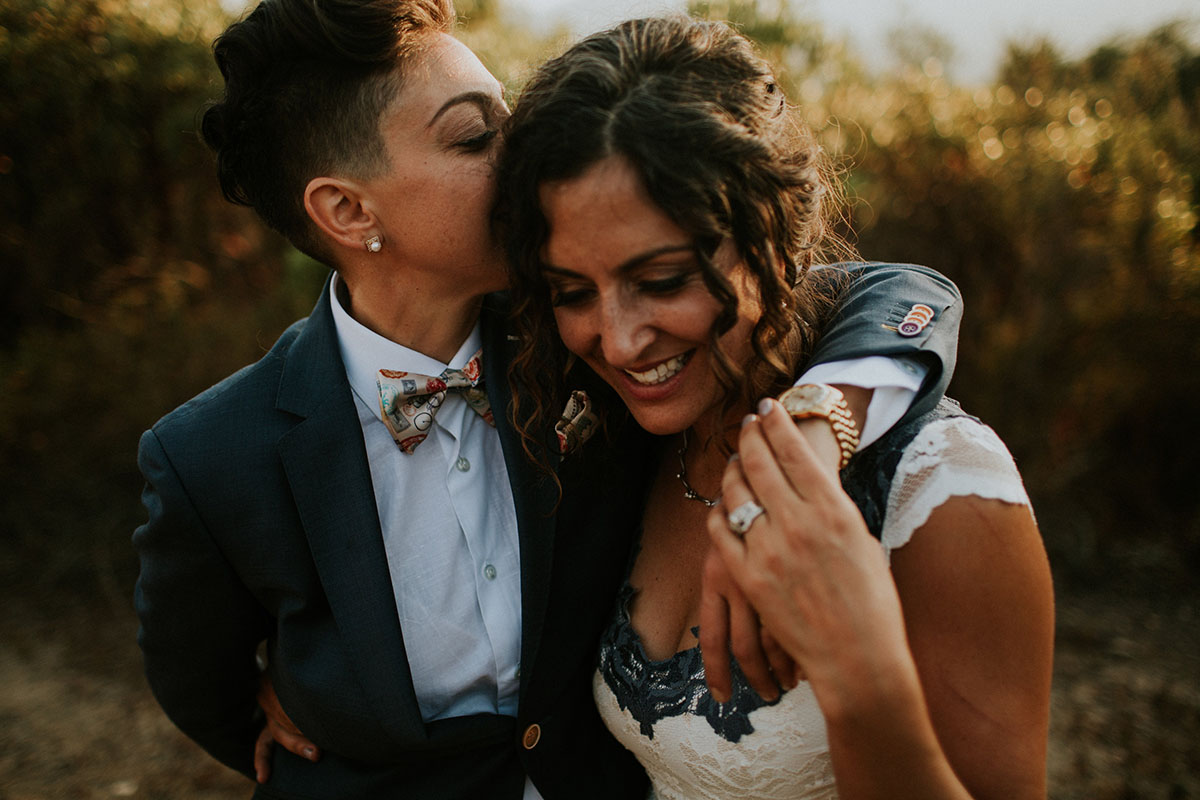 Mediterranean and Jewish wedding in wine country two brides same-sex lesbian wedding California long white dress gray lace suit