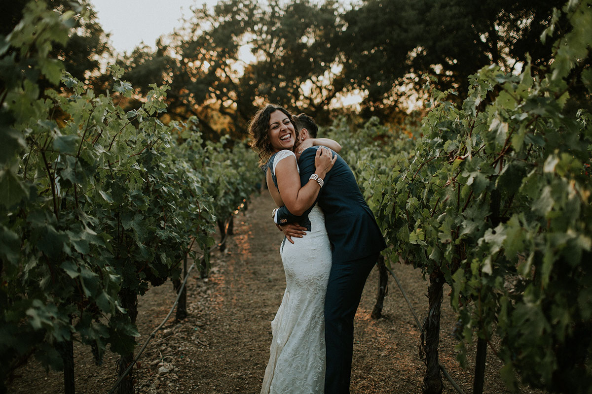Mediterranean and Jewish wedding in wine country two brides same-sex lesbian wedding California long white dress gray lace suit