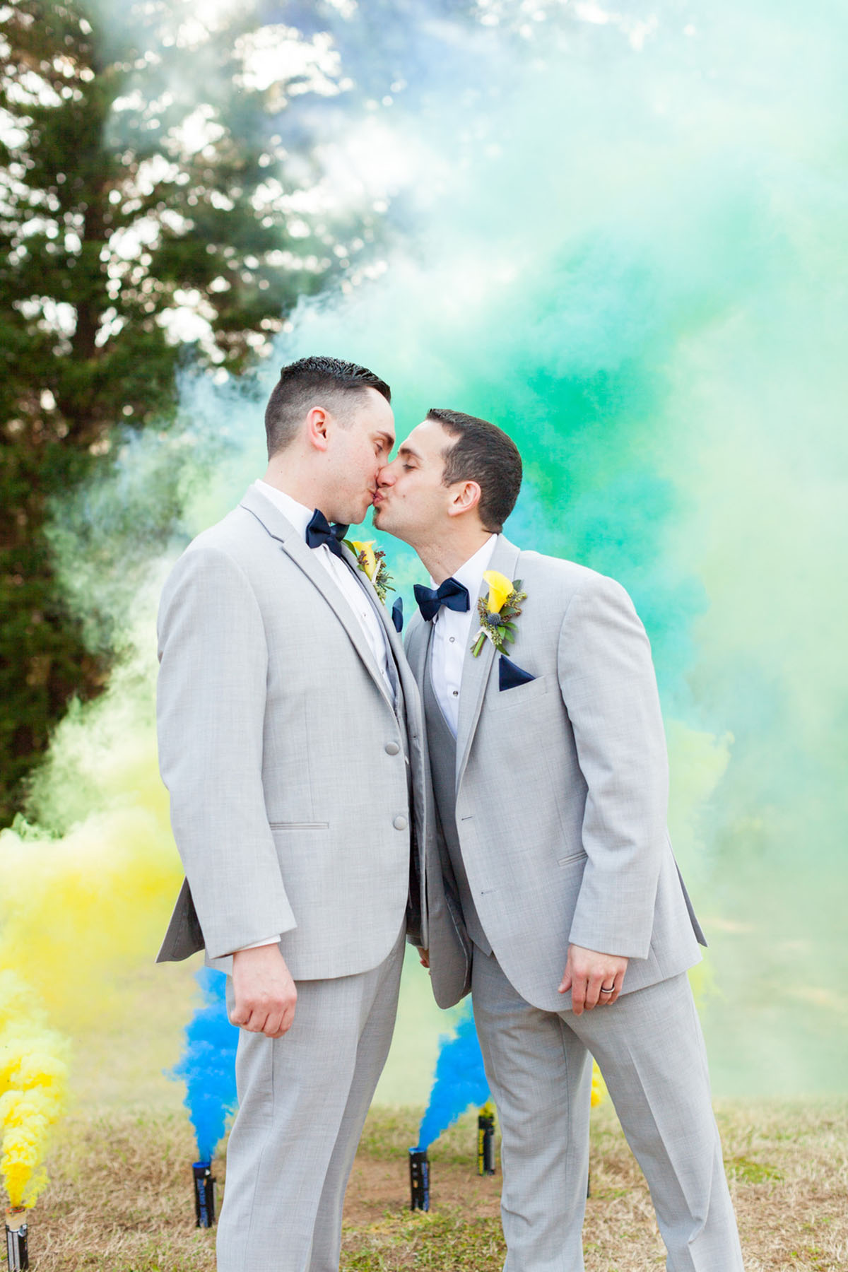 Blue and yellow spring wedding at the Lake Country Club two grooms gay wedding gray tuxes smoke bomb