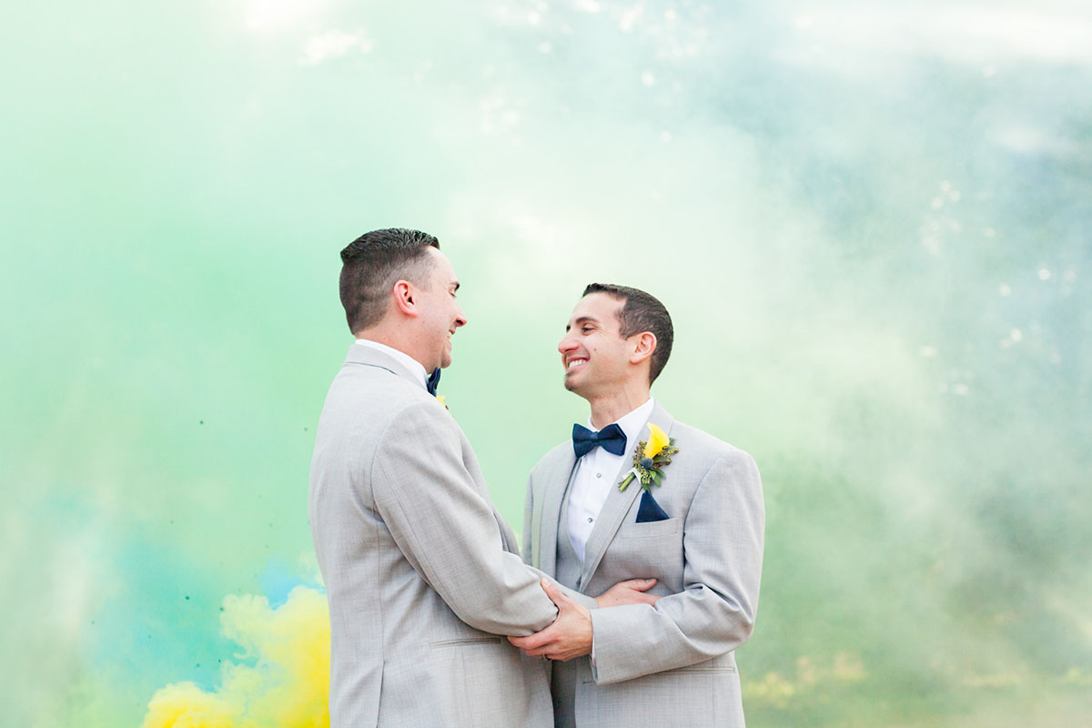 Blue and yellow spring wedding at the Lake Country Club two grooms gay wedding gray tuxes smoke bomb
