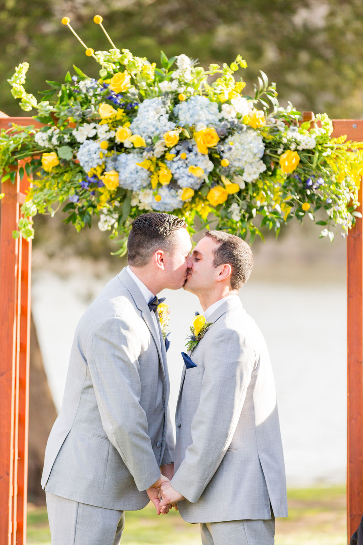 Blue and yellow spring wedding at the Lake Country Club two grooms gay wedding gray tuxes vows