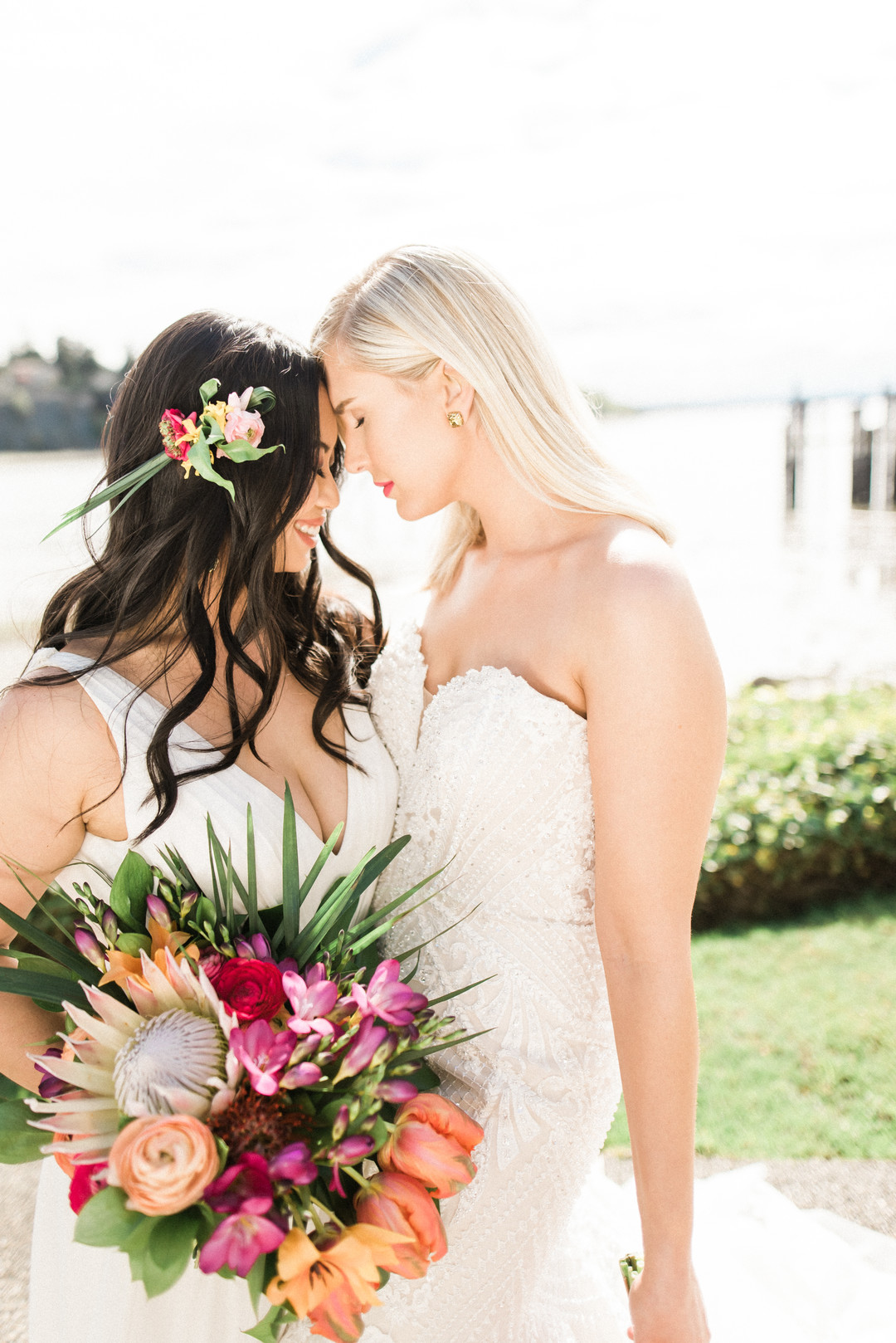 Bright, colorful Lilly Pulitzer spring wedding inspiration two brides palm tree leaves flamingos colorful waterfront