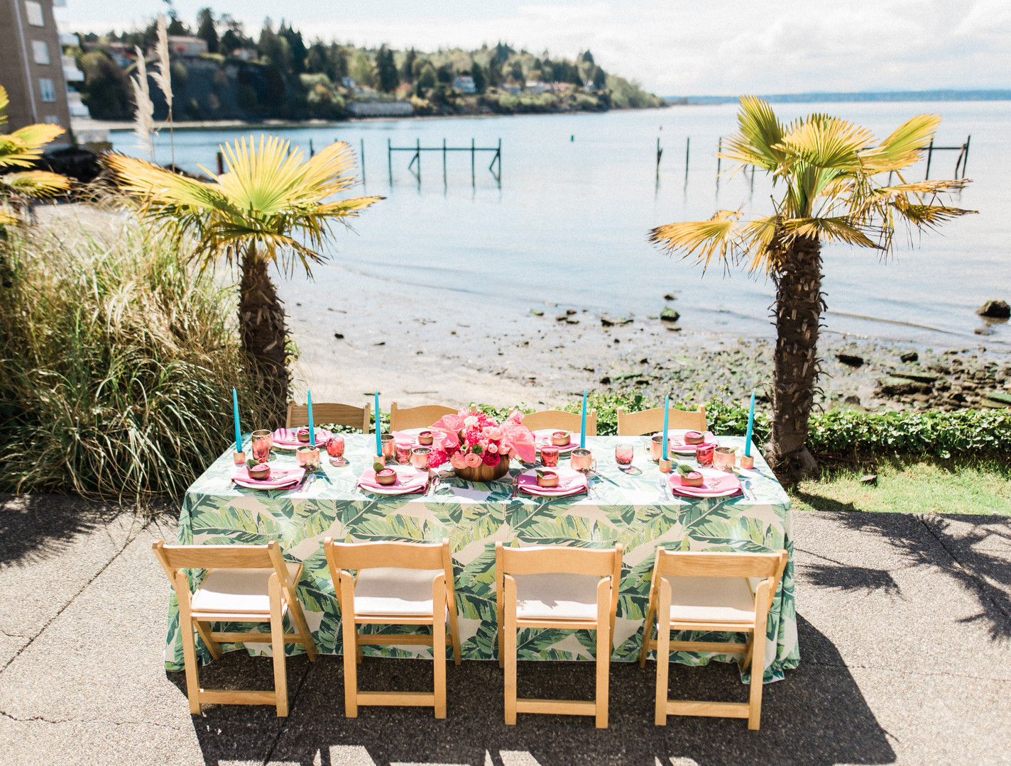 Bright, colorful Lilly Pulitzer spring wedding inspiration two brides palm tree leaves flamingos colorful waterfront table
