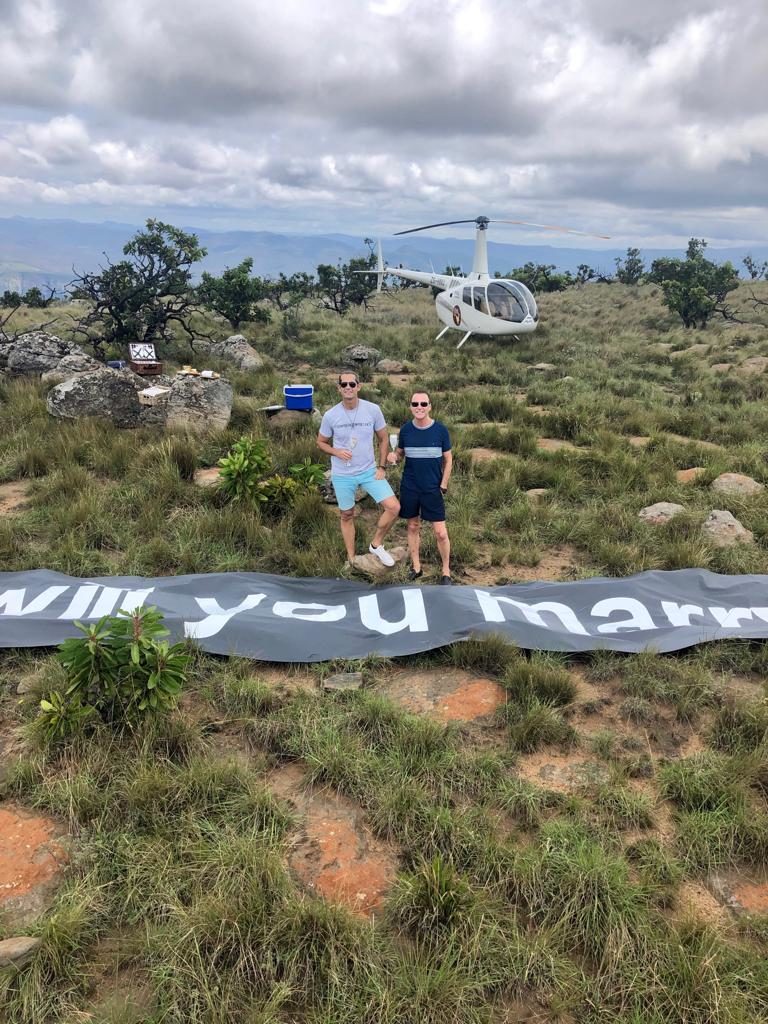 "Will you marry me?" sign that Colin Cowie had sprawled out for their engagement picnic where he proposed to Colin Cowie's extravagant proposal to Danny Peuscovich.