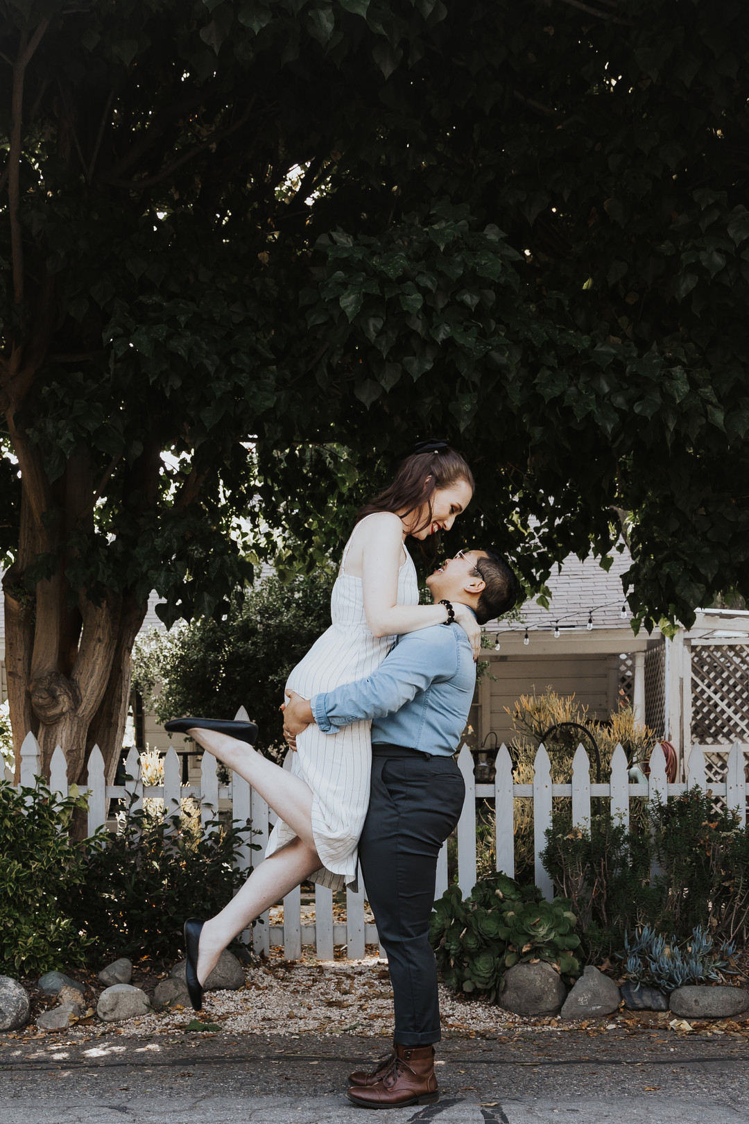 Engagement photos in the historic Los Rios district in California engaged two brides striped dress suspenders boots cuddling lift