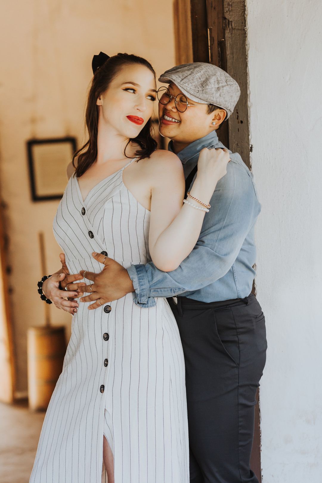 Engagement photos in the historic Los Rios district in California engaged two brides striped dress suspenders boots cuddling