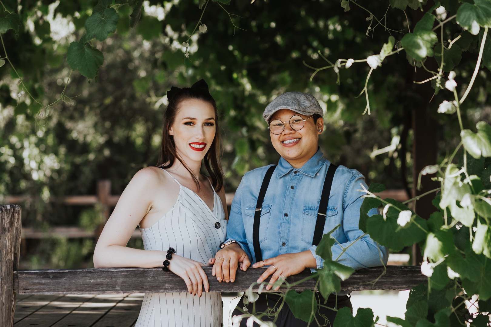 Engagement photos in the historic Los Rios district in California engaged two brides striped dress suspenders boots cuddling nature