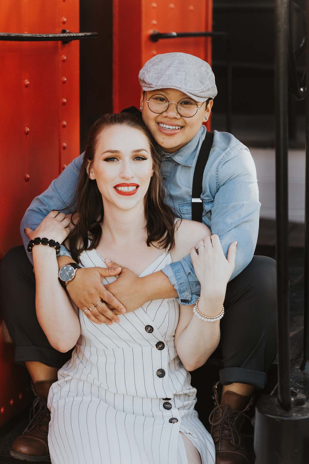 Engagement photos in the historic Los Rios district in California engaged two brides striped dress suspenders boots cuddling