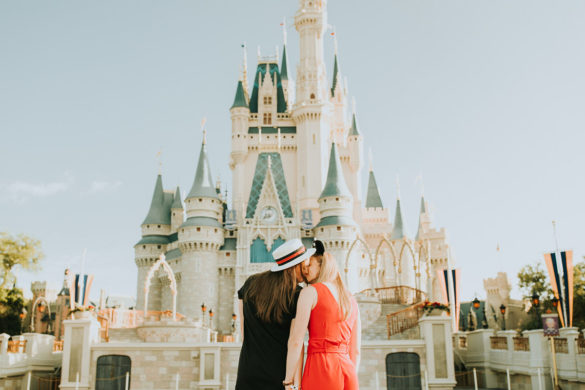 Fun, colorful engagement photos at Walt Disney World colorful red mouse ears coordinated outfits two brides same-sex lesbian engagement cinderella castle
