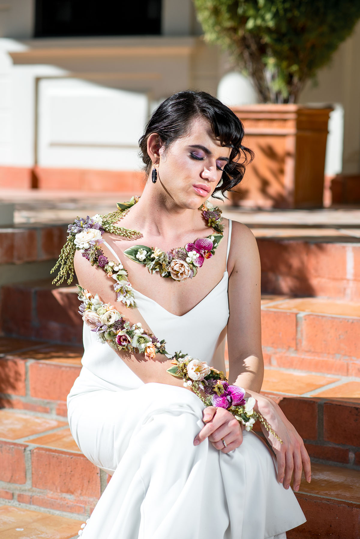 Moody floral fairy tale wedding inspiration with fashion from three eras contemporary vintage modern trans wedding looks dresses hair makeup bridal beauty LGBTQ+