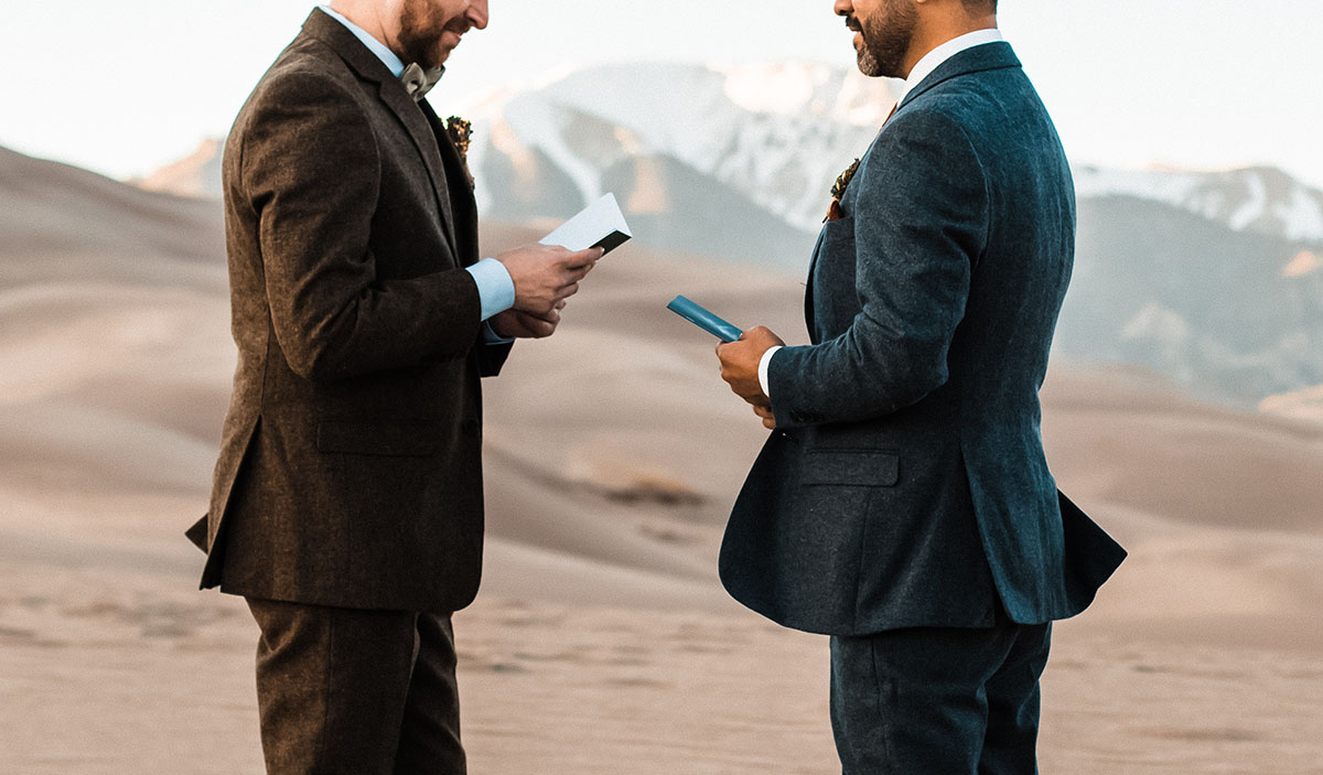 Sunset and sand dunes adventure elopement two grooms suits gay wedding intimate nature
