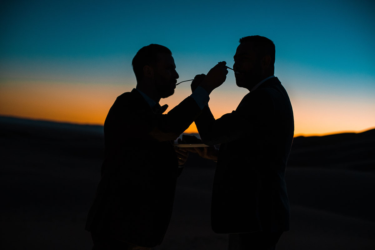 Sunset and sand dunes adventure elopement two grooms suits gay wedding intimate nature