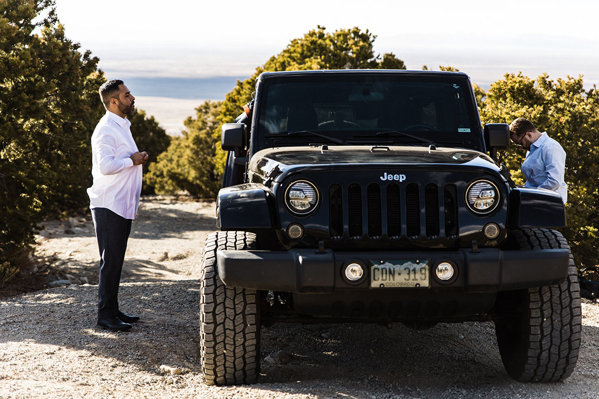 Sunset and sand dunes adventure elopement two grooms suits gay wedding intimate nature jeep