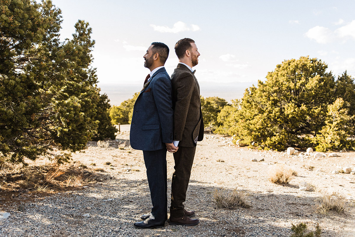Sunset and sand dunes adventure elopement two grooms suits gay wedding intimate nature first look