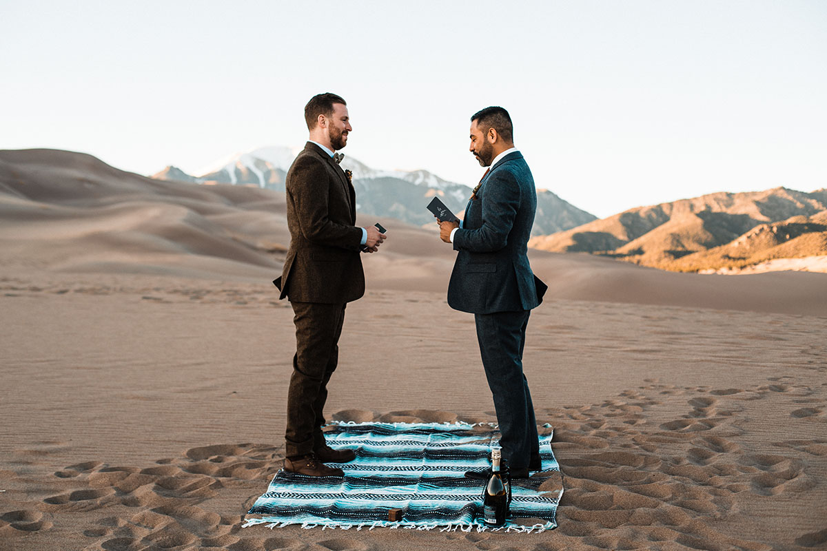 Sunset and sand dunes adventure elopement two grooms suits gay wedding intimate nature vows