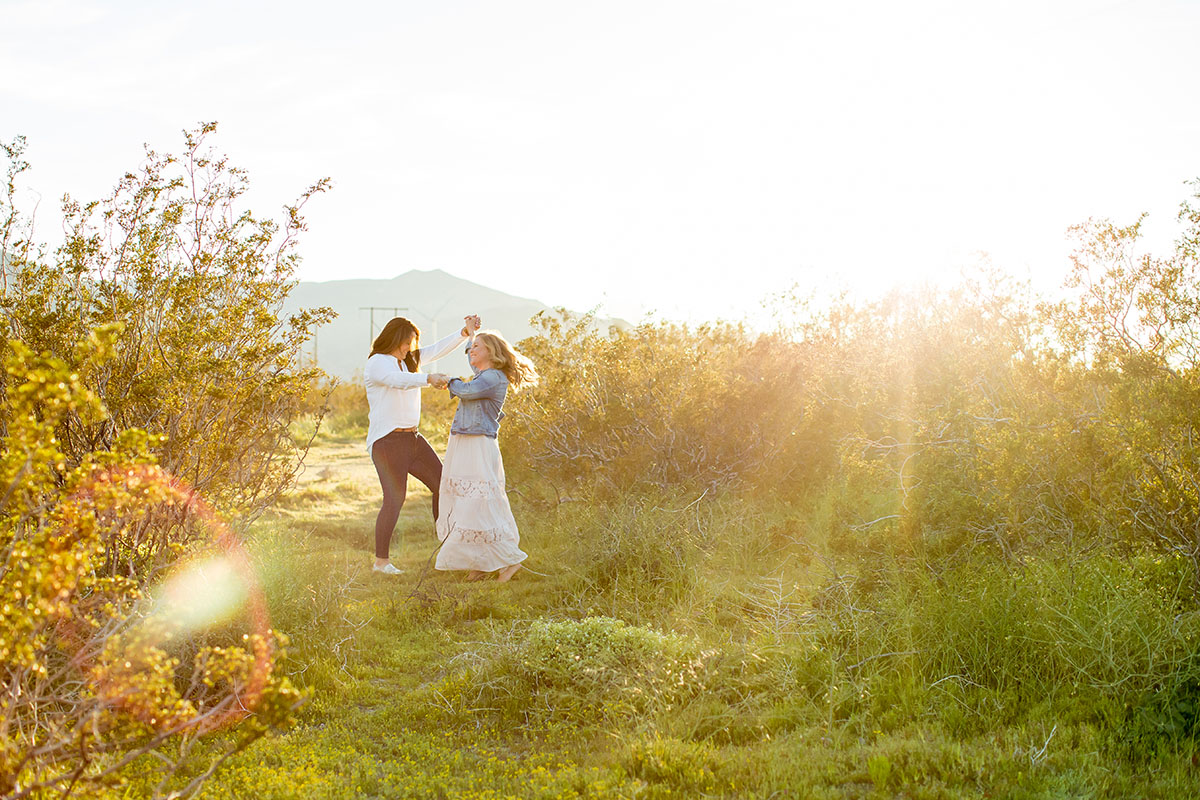 Sunset engagement photos in Palm Springs, California two brides engagement outdoors romantic dancing