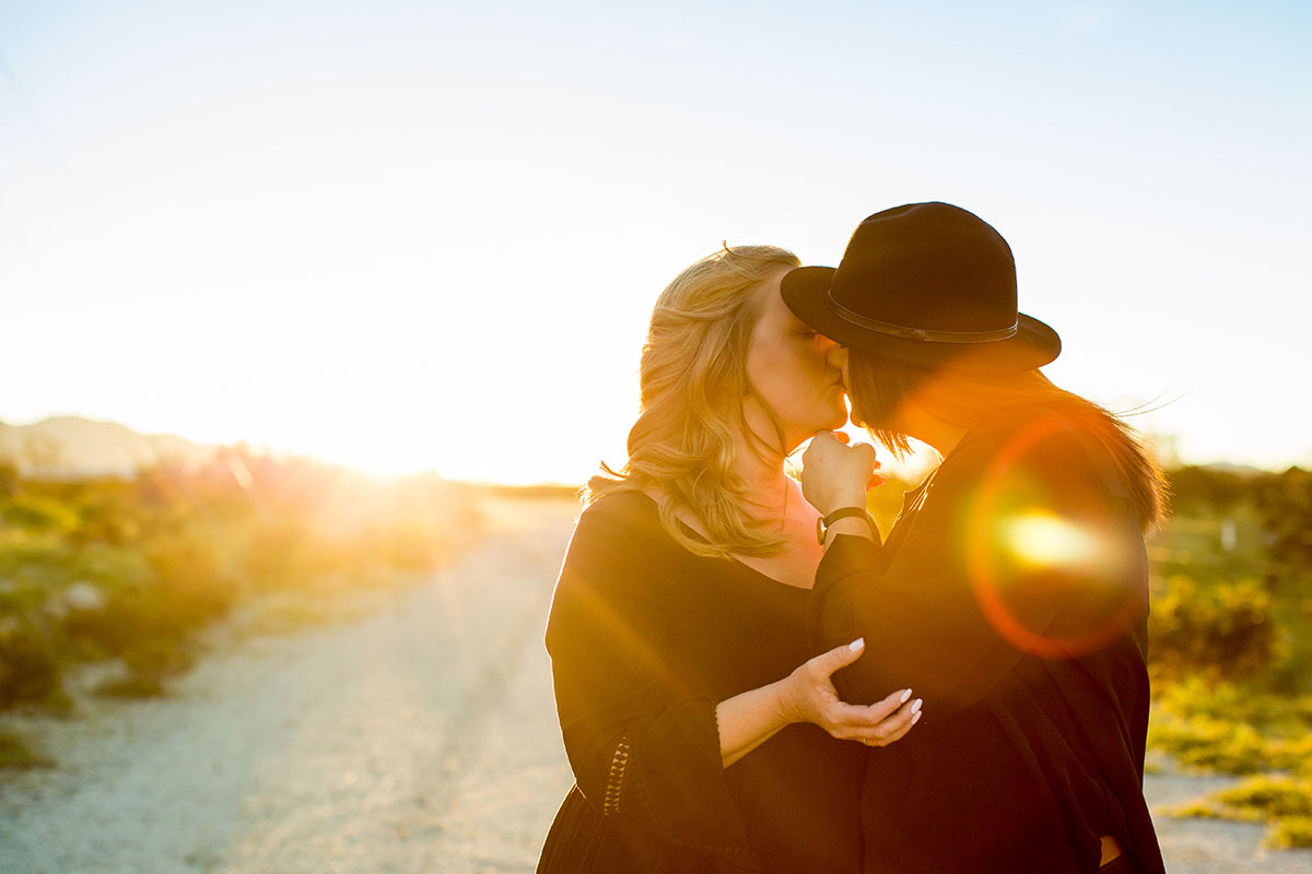 Sunset engagement photos in Palm Springs, California two brides engagement outdoors romantic kiss