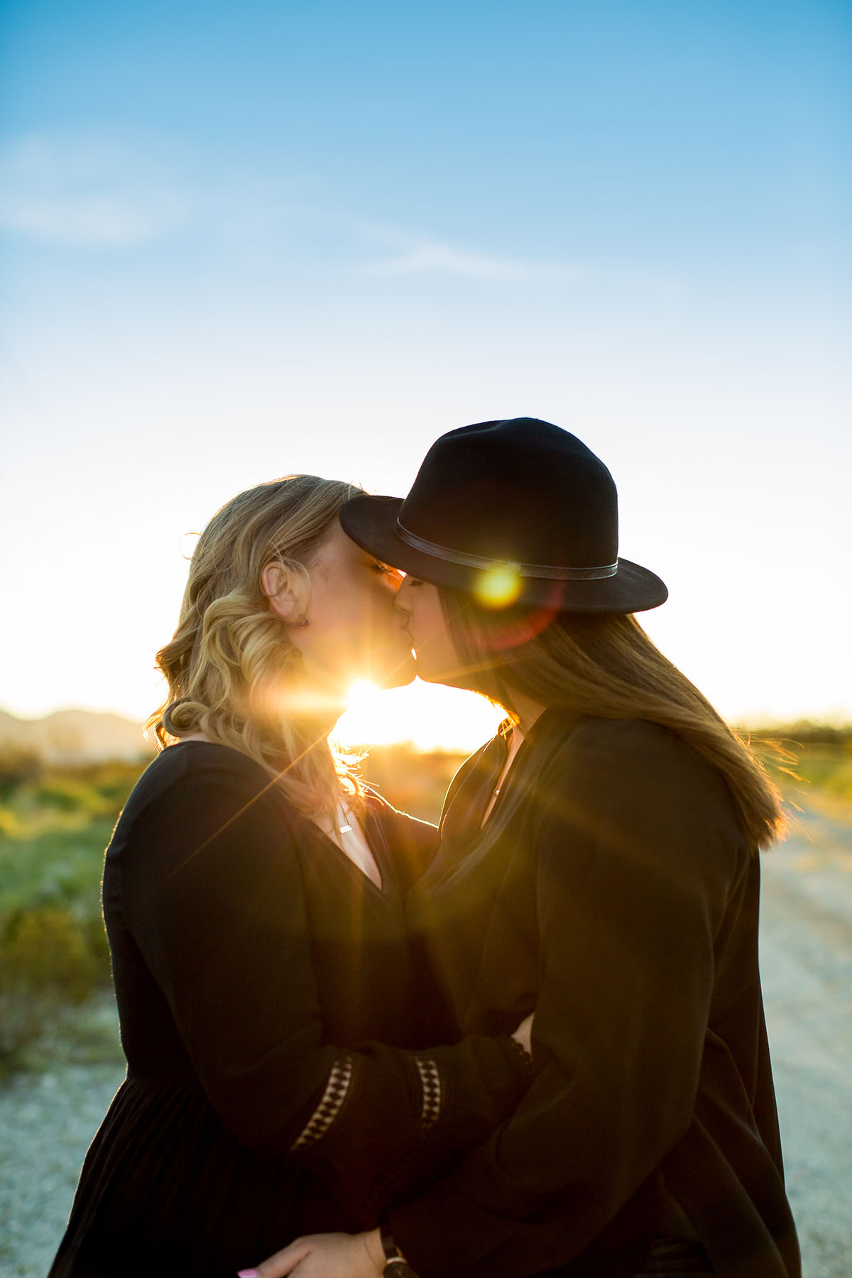 Sunset engagement photos in Palm Springs, California two brides engagement outdoors romantic kiss