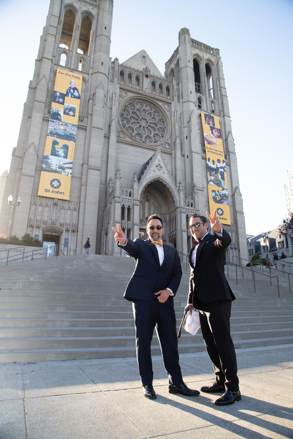 Elegant cathedral wedding in San Francisco, California two grooms black tuxedos outside church