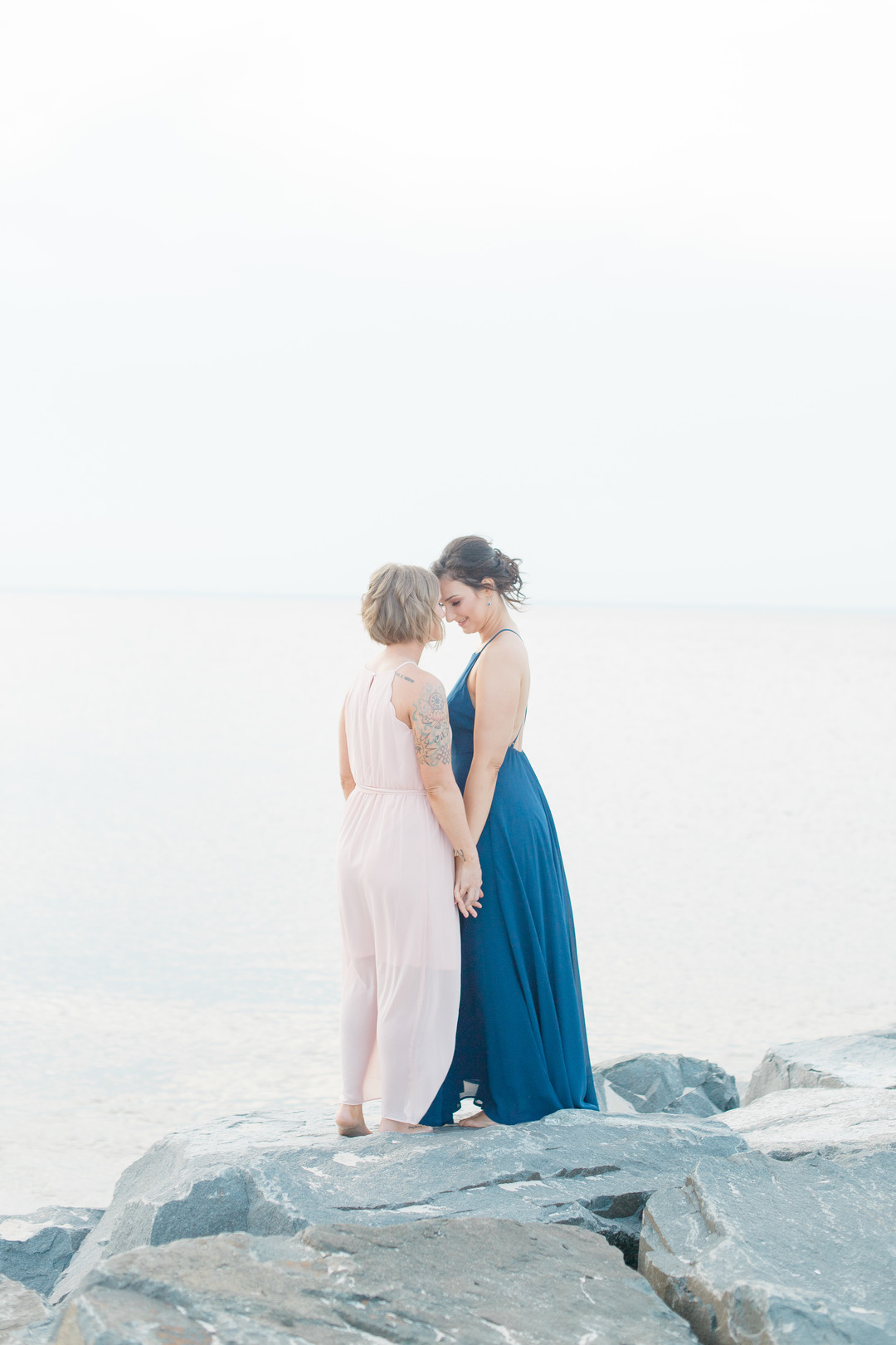 Beach engagement photos at Bayshore Waterfront Park two brides same-sex engagement pink dress blue dress