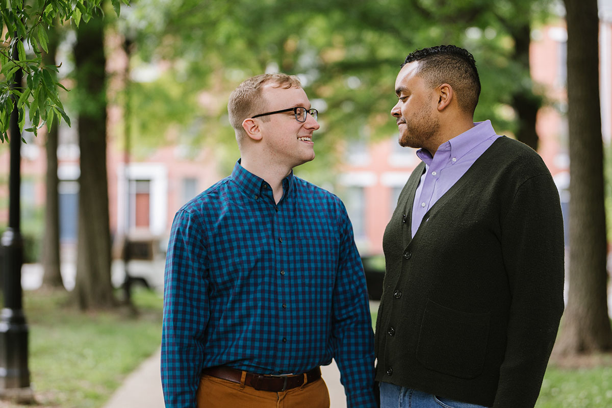 Boat rides and dog walks during loving Baltimore engagement photos two grooms