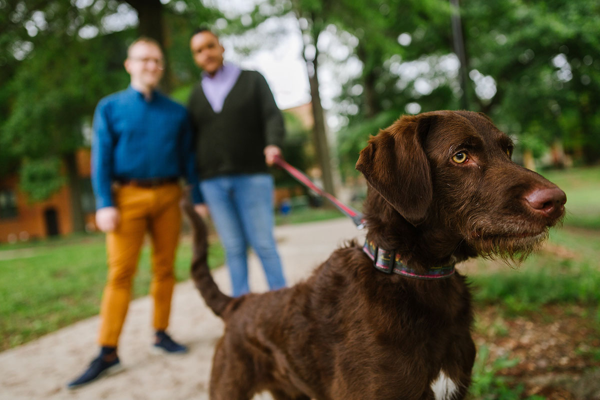 Boat rides and dog walks during loving Baltimore engagement photos two grooms dog
